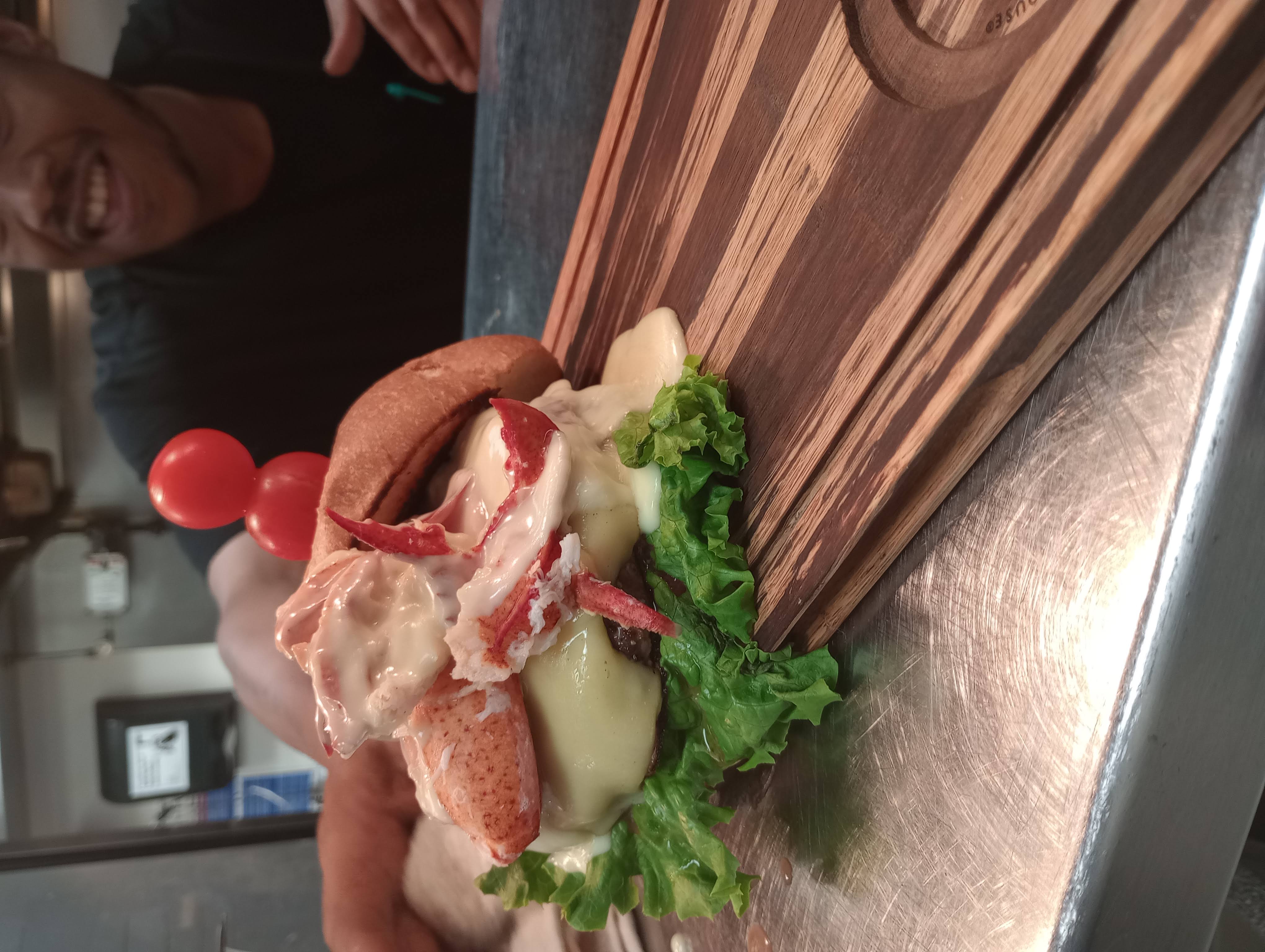 Chef finishing burger pass in active service